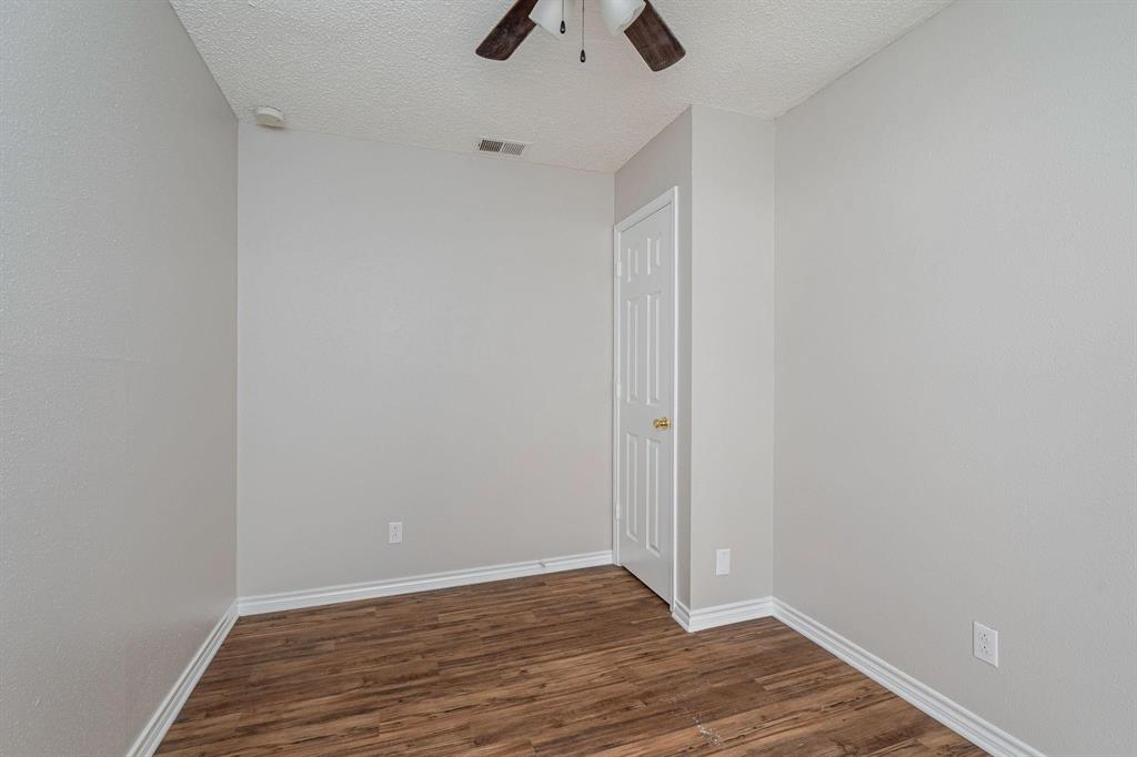 900 South Tennessee Street, Unit 13 McKinney, TX 75069 - Photo 7 of 16 a view of an empty room with wooden floor