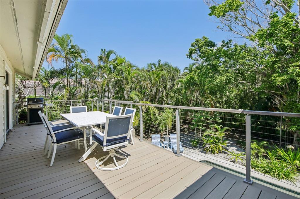 3390 Bayou Sound Longboat Key, FL 34228 - Photo 12 of 59 a view of a chairs and table on the wooden deck