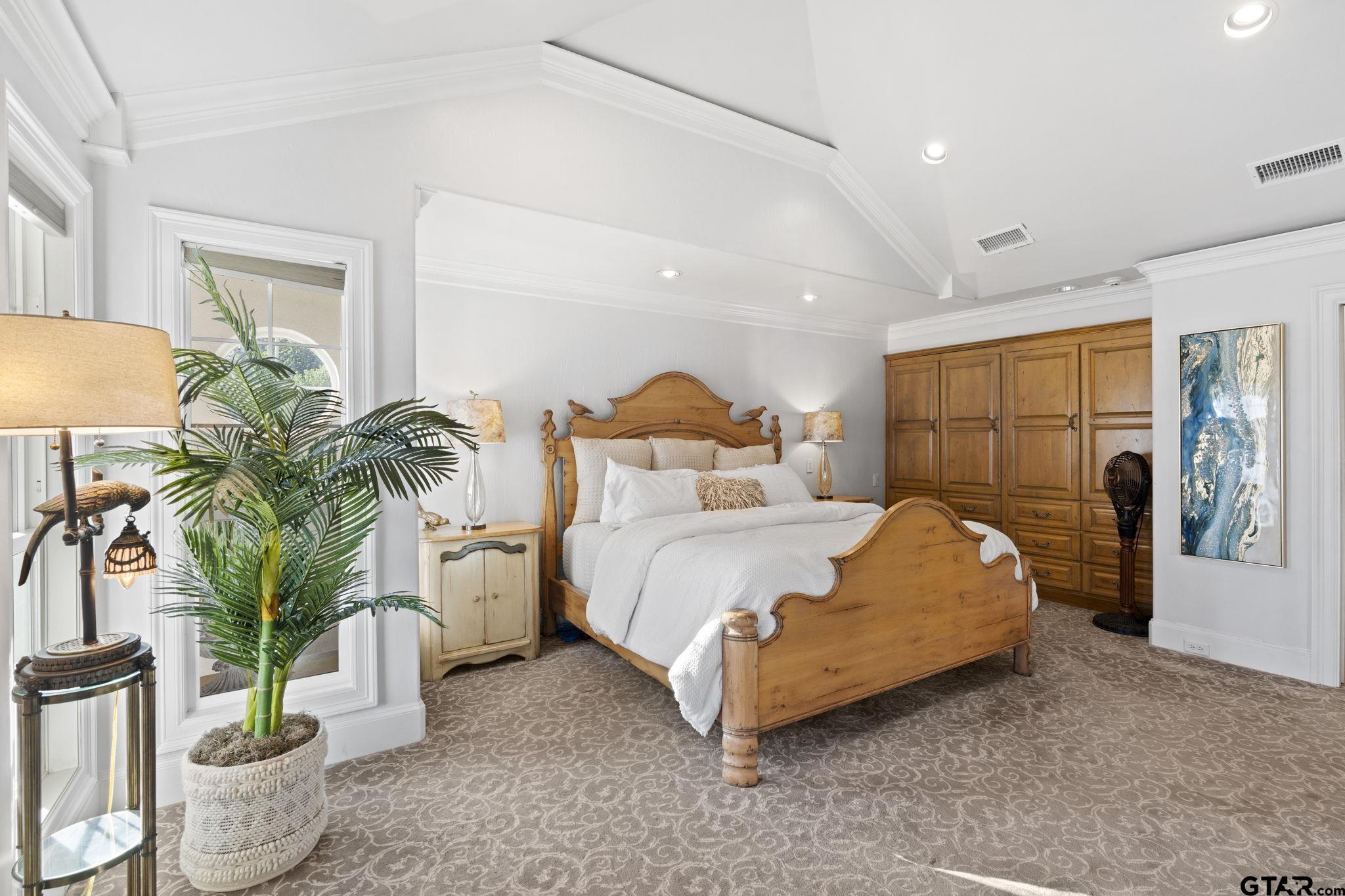 15996 Eastside Road Tyler, TX 75707 - Photo 22 of 48 a bedroom with bed and a potted plant