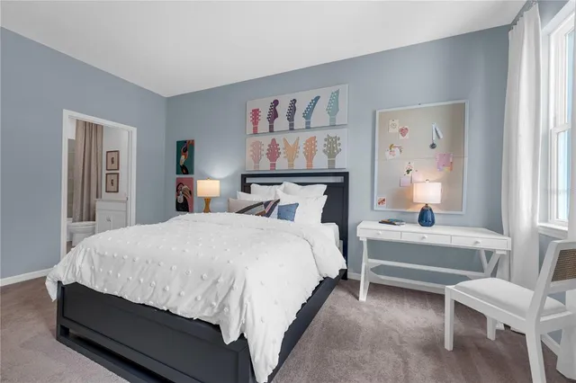 a bedroom with a bed and a large mirror