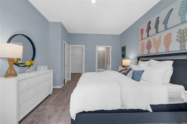 a bedroom with a bed and dresser