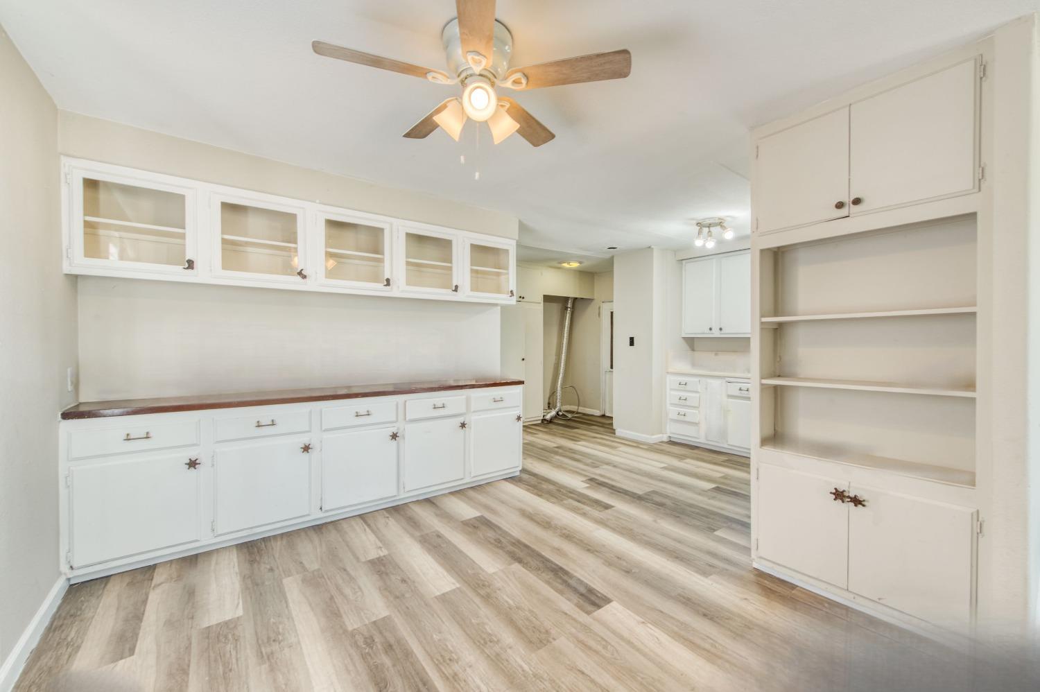 3658 South Butte Avenue Kerman, CA 93630 - Photo 14 of 20 a room with closet and wooden cabinet