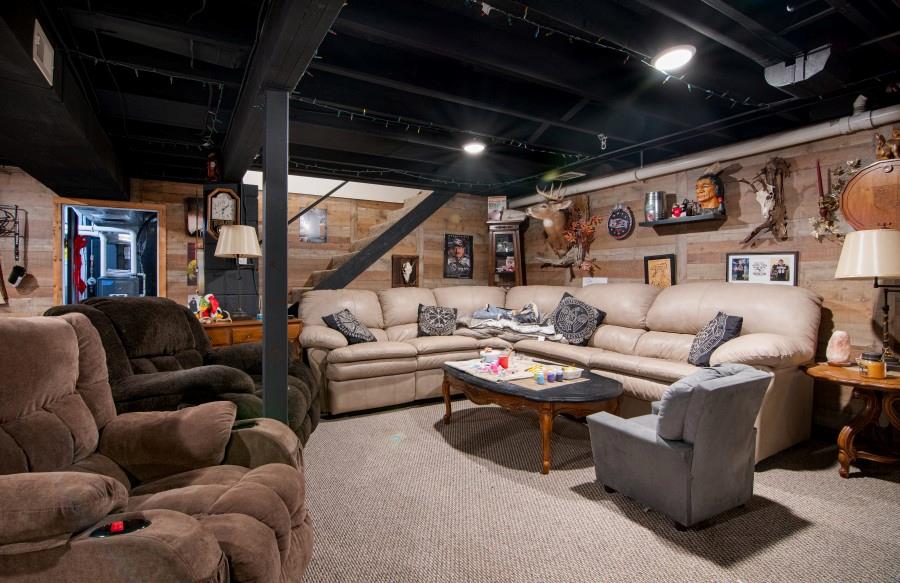 114 Dolphin Drive Butler, PA 16002 - Photo 13 of 25 a living room with furniture a ceiling fan and a projector
