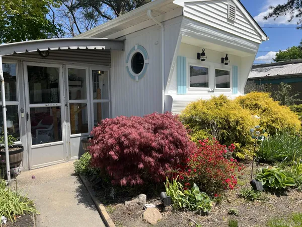 a view of a house with a yard and garden