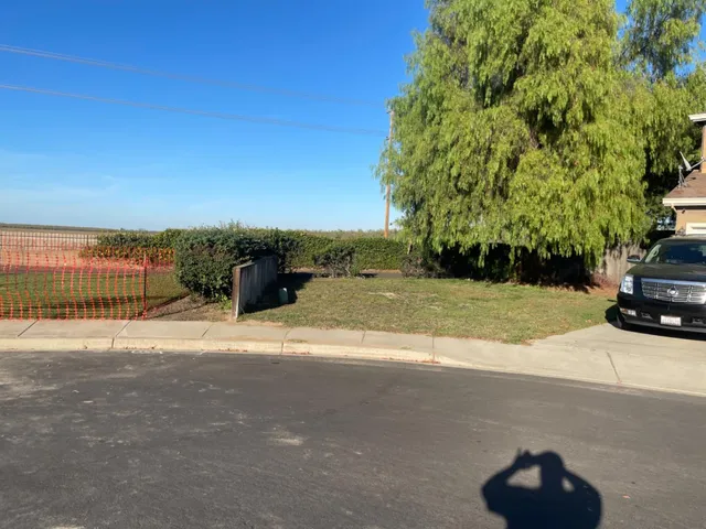 a view of a street with a car parked on the road