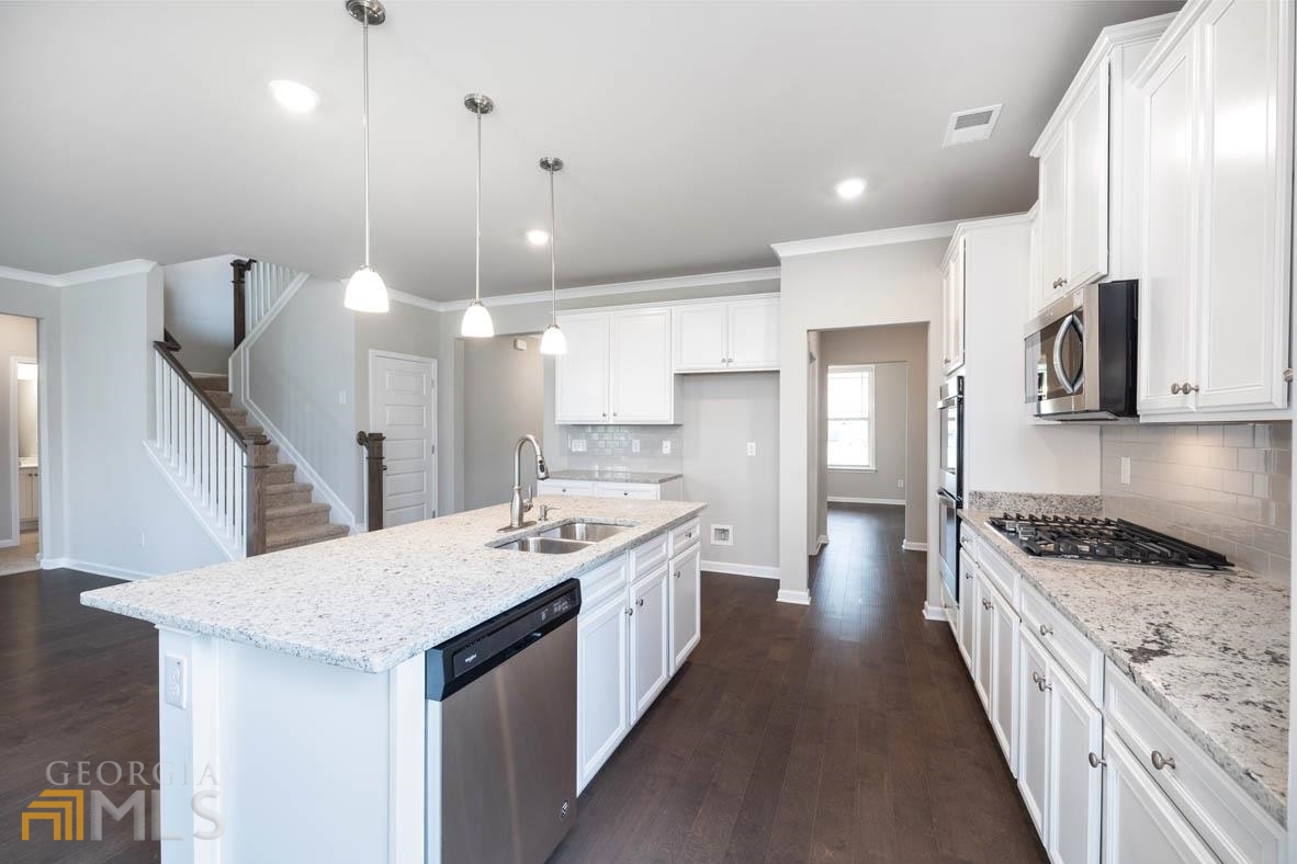 1908 Endress Circle Hampton, GA 30228 - Photo 15 of 44 a kitchen with a sink stove and refrigerator