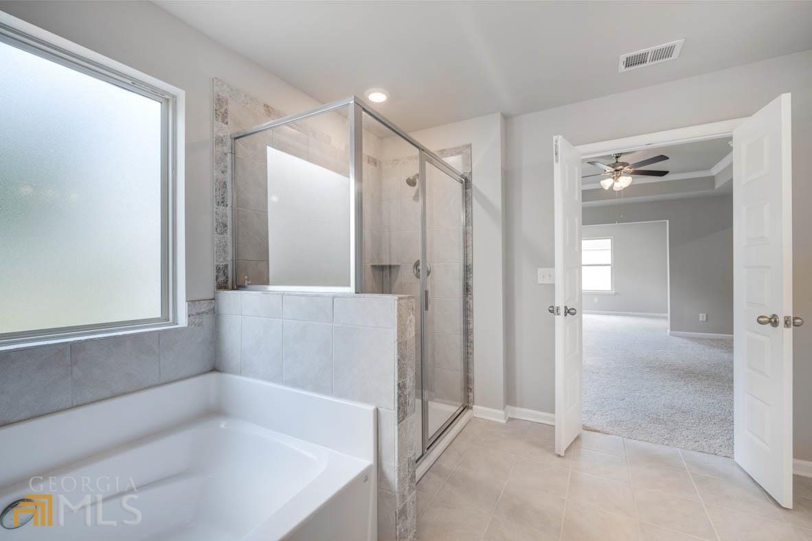 1908 Endress Circle Hampton, GA 30228 - Photo 23 of 44 a bathroom with a bathtub and a shower