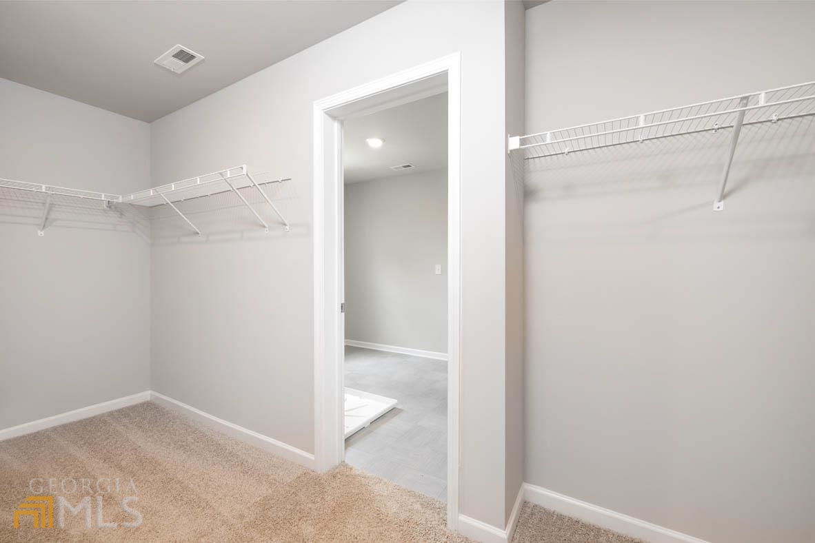 1908 Endress Circle Hampton, GA 30228 - Photo 37 of 44 a view of an empty walk in closet and a bathroom