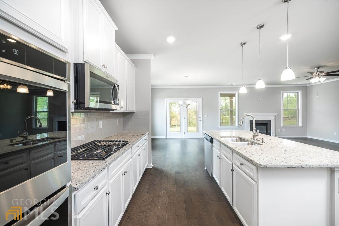 1908 Endress Circle Hampton, GA 30228 - Photo 5 of 44 a large kitchen with stainless steel appliances a stove sink and cabinets