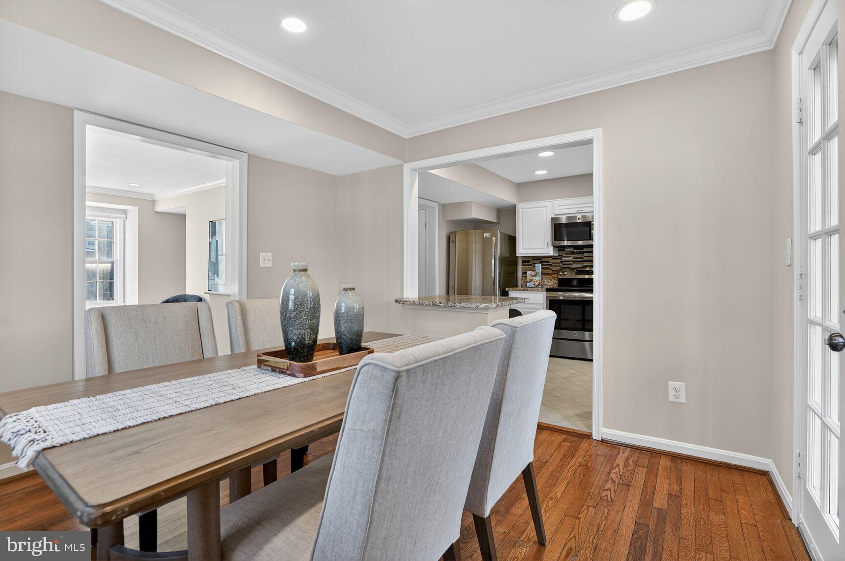 6630 Hillandale Road, Unit 56 Chevy Chase, MD 20815 - Photo 18 of 40 a view of a dining room with furniture and wooden floor