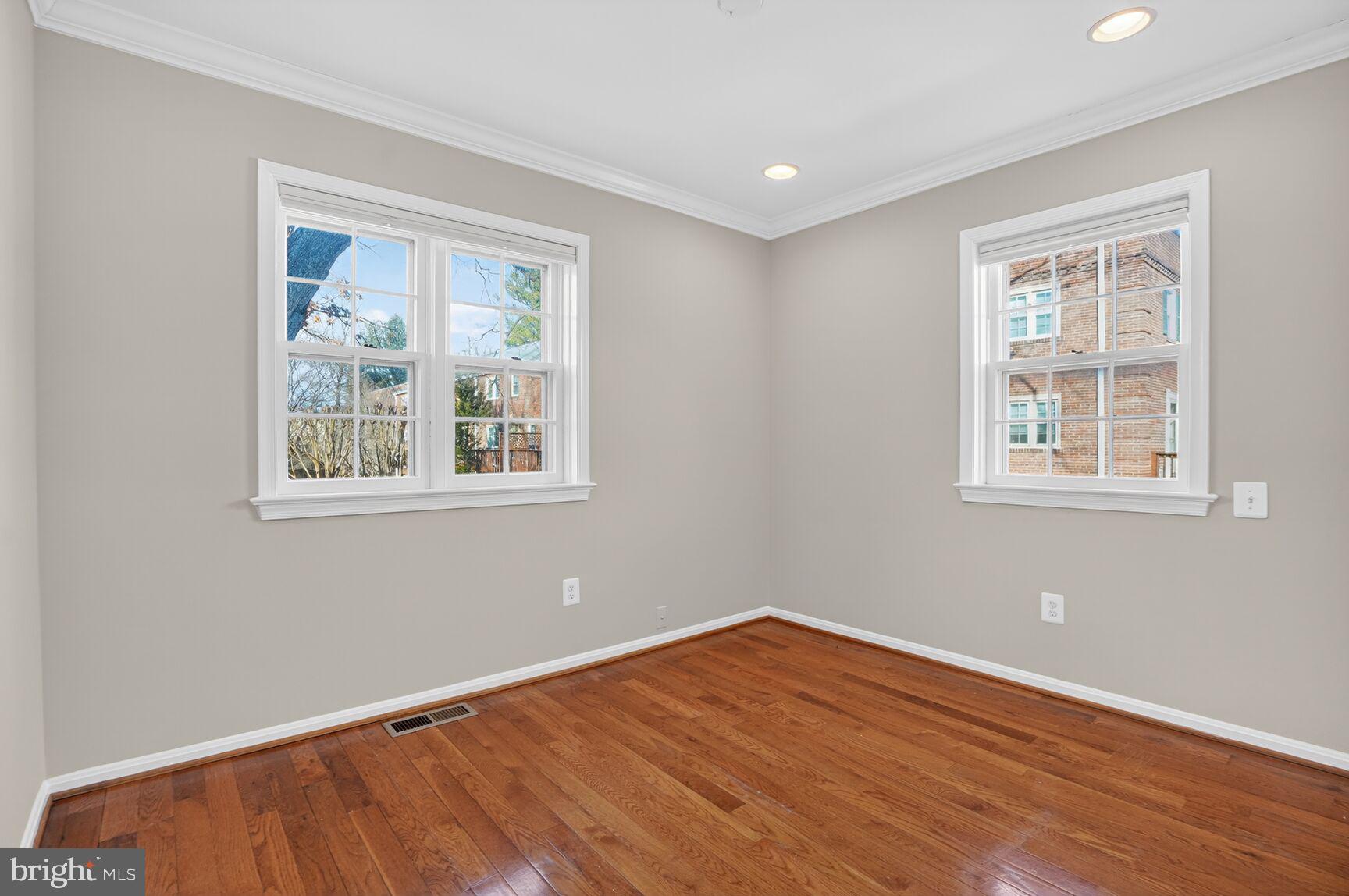 6630 Hillandale Road, Unit 56 Chevy Chase, MD 20815 - Photo 28 of 40 a view of an empty room with wooden floor and a window