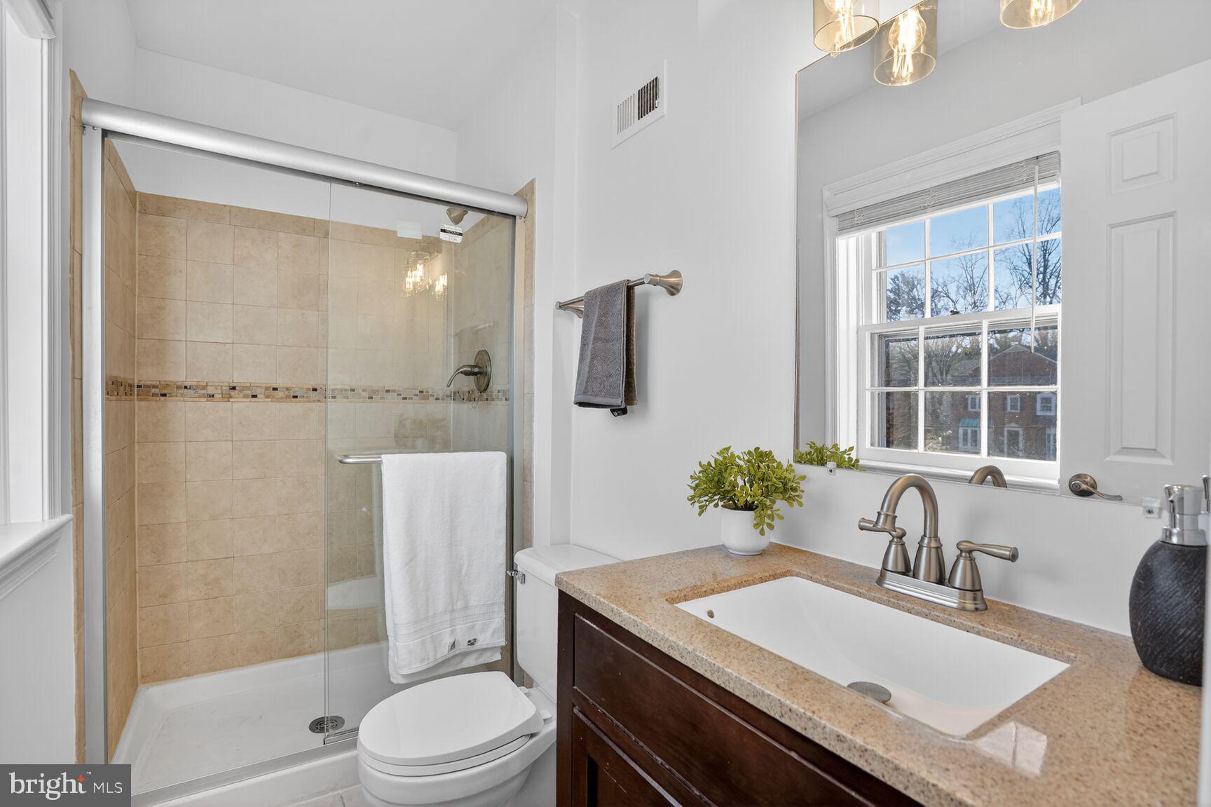 6630 Hillandale Road, Unit 56 Chevy Chase, MD 20815 - Photo 32 of 40 a bathroom with a sink toilet a mirror and shower