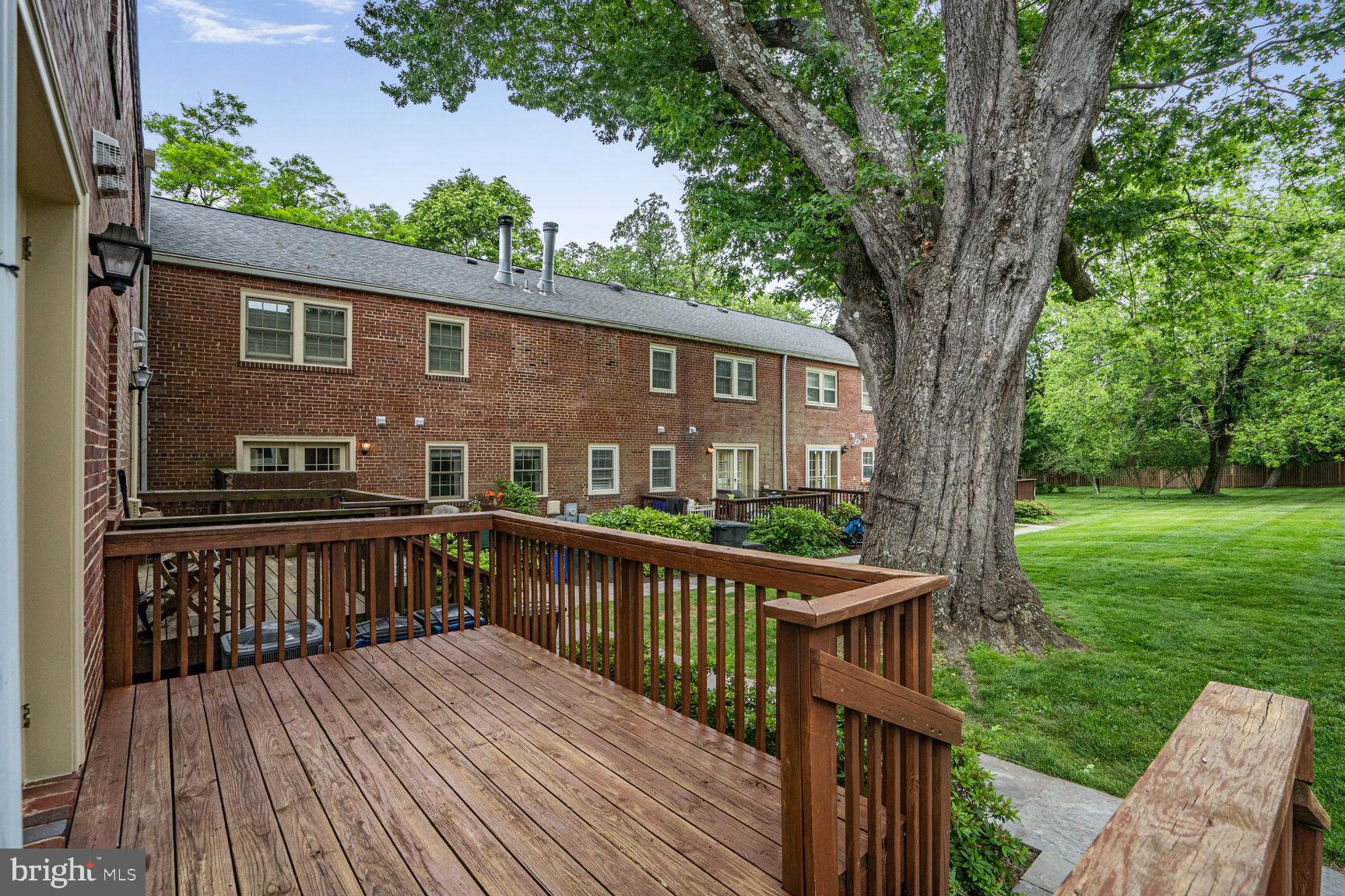 6630 Hillandale Road, Unit 56 Chevy Chase, MD 20815 - Photo 36 of 40 a front view of a house with yard and deck
