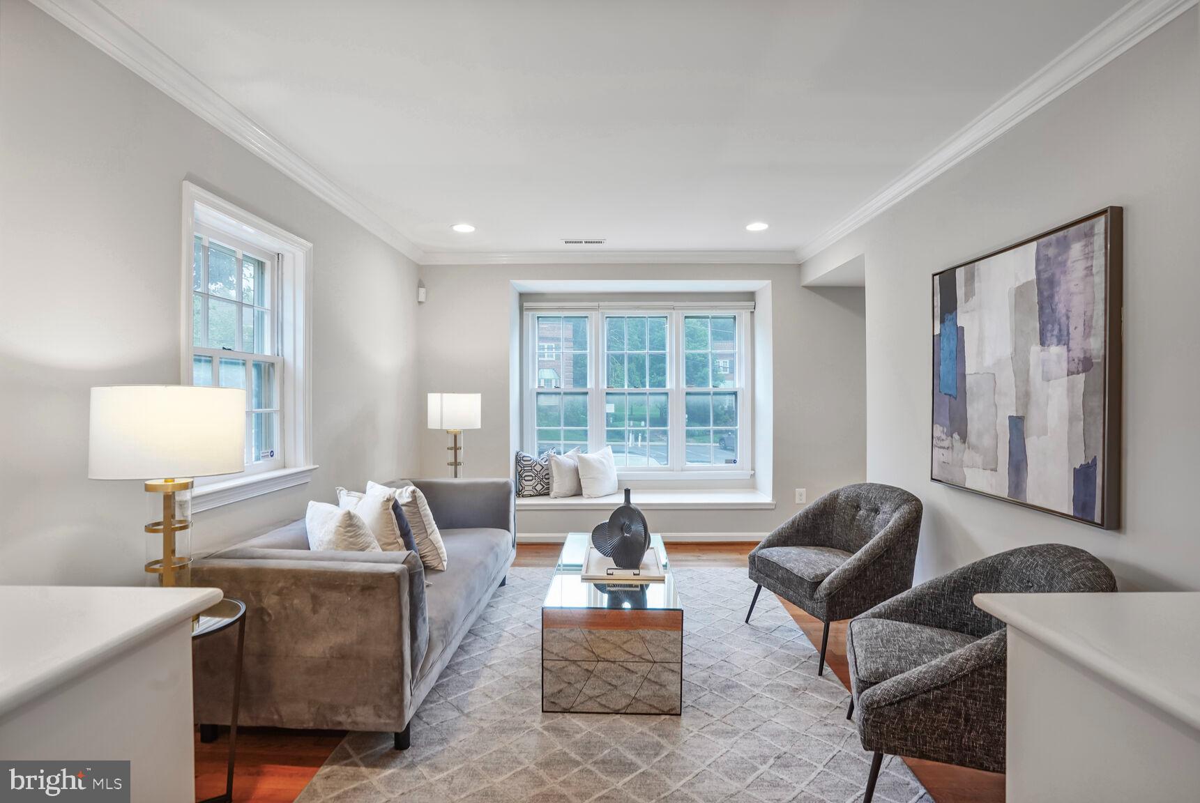 6630 Hillandale Road, Unit 56 Chevy Chase, MD 20815 - Photo 7 of 40 a living room with furniture and a large window