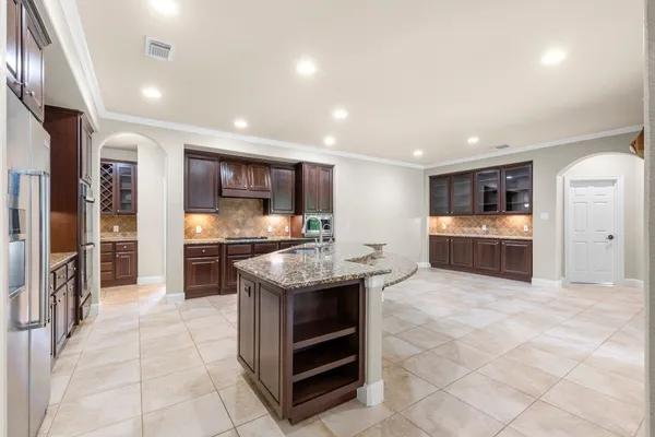 a kitchen with stainless steel appliances granite countertop a stove and a refrigerator