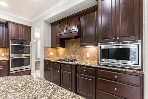 a kitchen with granite countertop stainless steel appliances and cabinets