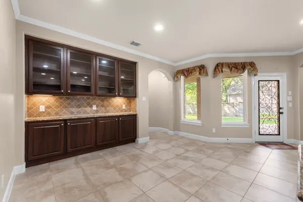 a large kitchen with granite countertop a sink and cabinets