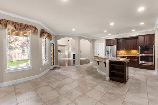 a large kitchen with stainless steel appliances lots of counter top space
