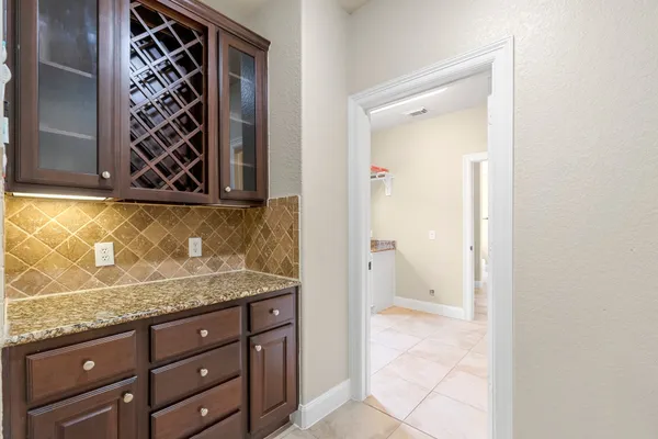 a view of bathroom with a granite countertop sink and a mirror