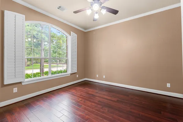 a view of wooden floor and windows in a room