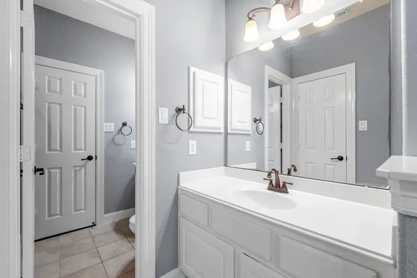 a bathroom with a sink a mirror and a shower