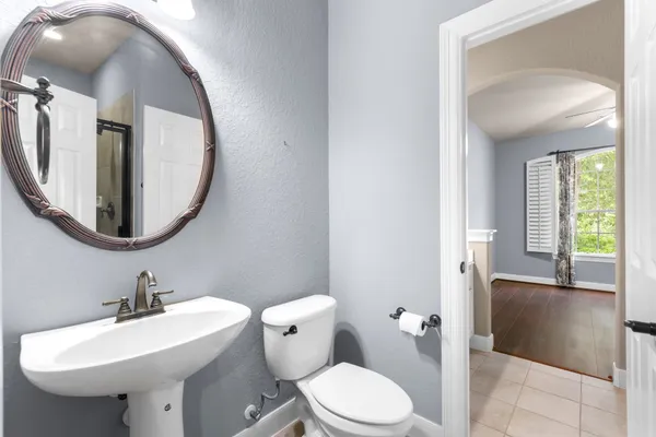 a bathroom with a sink a mirror and a toilet
