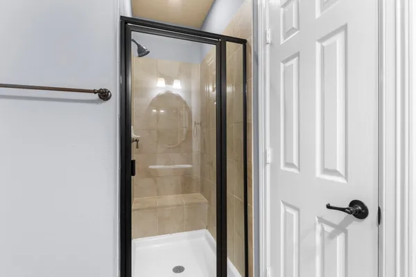 a bathroom with a glass shower door