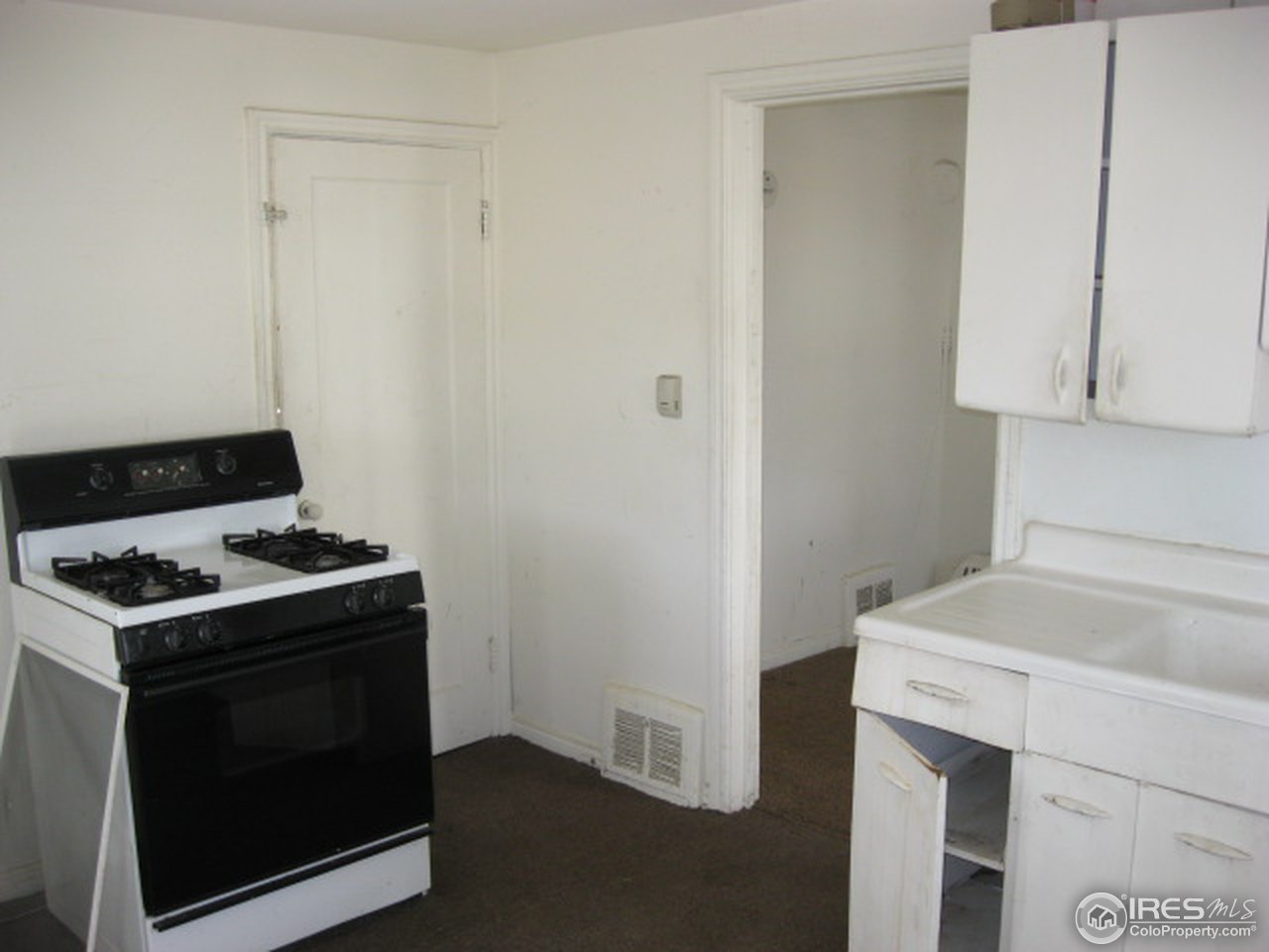525 Jackson Street Sterling, CO 80751 - Photo 4 of 9 a kitchen with a stove and a sink