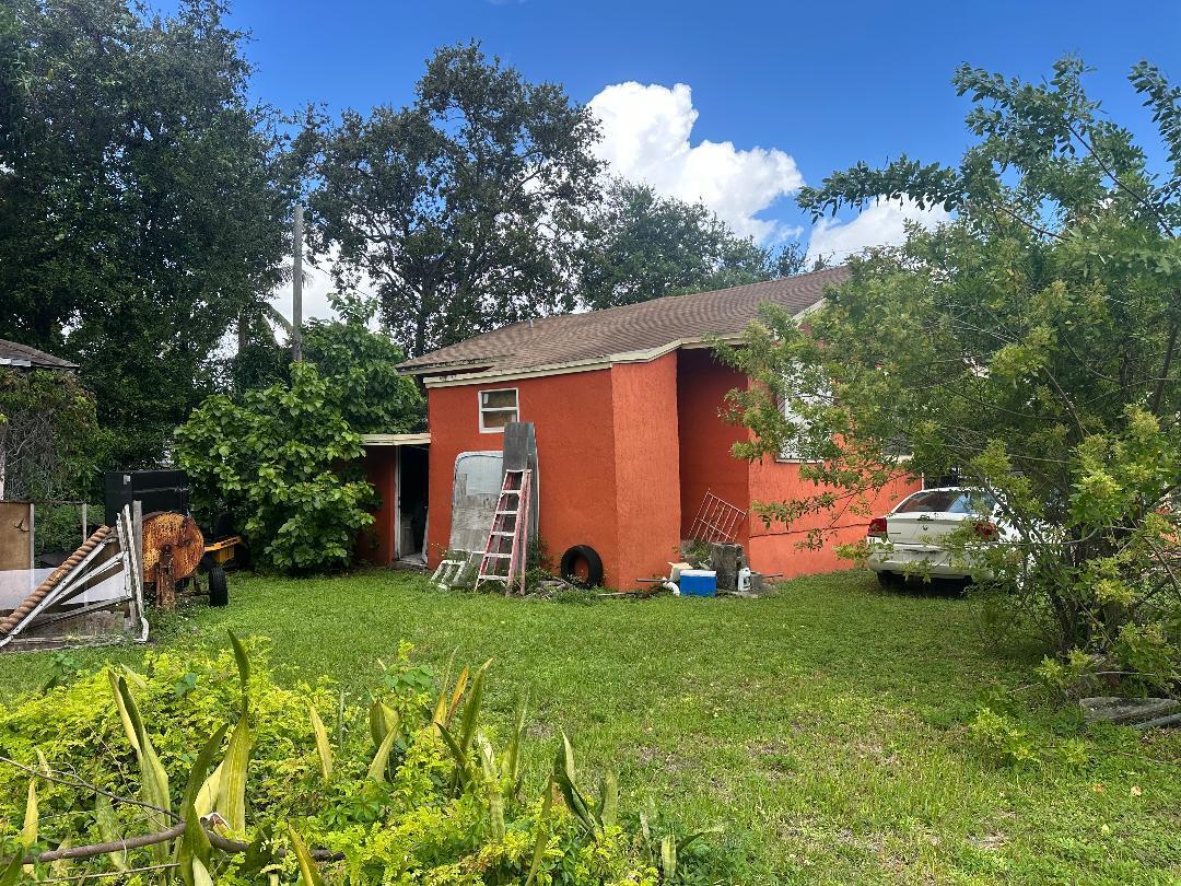 262 Northwest 58th Street Miami, FL 33127 - Photo 6 of 6 a front view of a house with garden