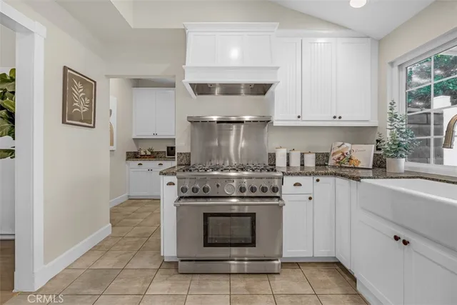 a kitchen with granite countertop cabinets a dining table and chairs