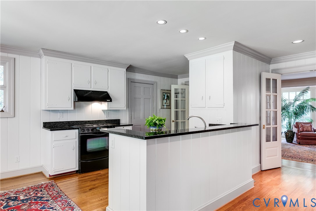 10475 Cherokee Road Richmond, VA 23235 - Photo 14 of 74 Kitchen featuring white cabinetry, black stone cou