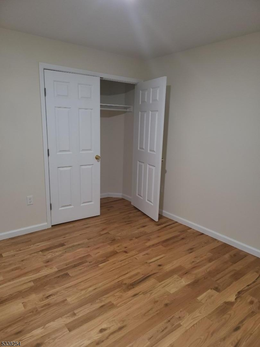 487 South 18th Street, Unit 1 Newark, NJ 07103 - Photo 14 of 22 a view of an empty room and wooden floor