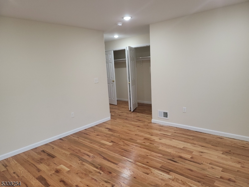 487 South 18th Street, Unit 1 Newark, NJ 07103 - Photo 18 of 22 a view of an empty room with wooden floor