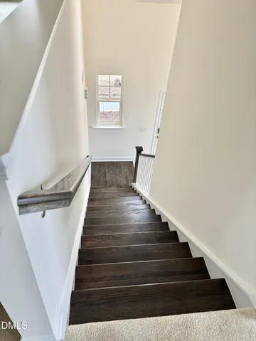 a large kitchen with stainless steel appliances a large counter top a stove and a refrigerator