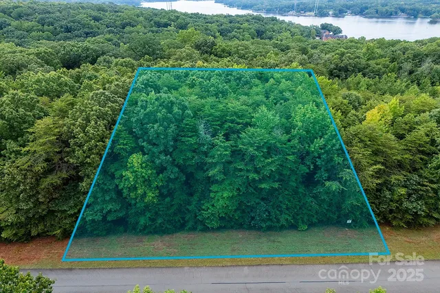an aerial view of a house with outdoor space and lake view