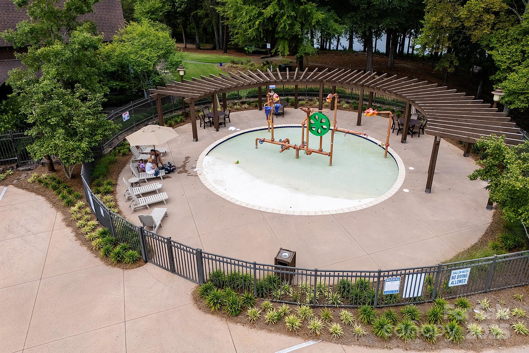 13703 Girl Scout Road, Unit 157 Charlotte, NC 28278 - Photo 18 of 23 a backyard of a house with yard and outdoor seating