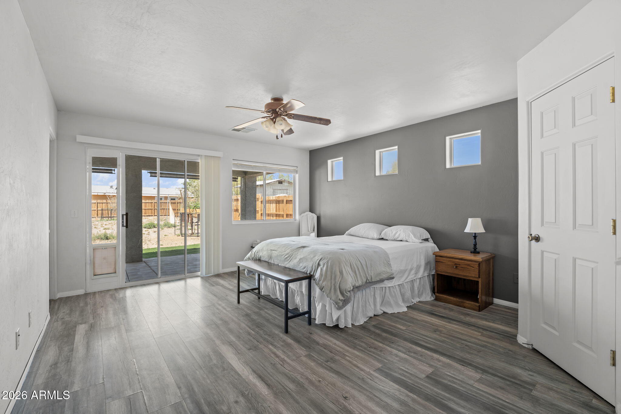 27144 Bennett Way Congress, AZ 85332 - Photo 11 of 33 a spacious bedroom with a bed and wooden floor