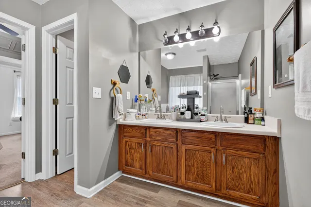 a bathroom with a double vanity sink and a mirror