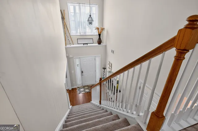 a view of entryway and hall with wooden floor