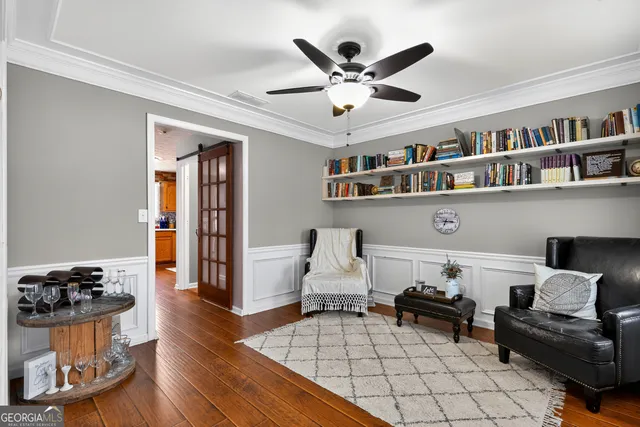 a living room with furniture and a book shelf