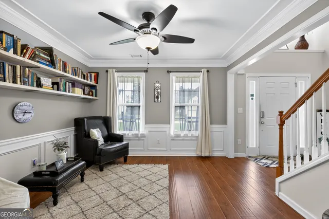 a living room with furniture and a book shelf