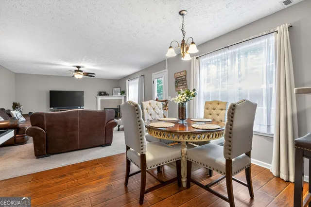 a view of a dining room with furniture window and wooden floor
