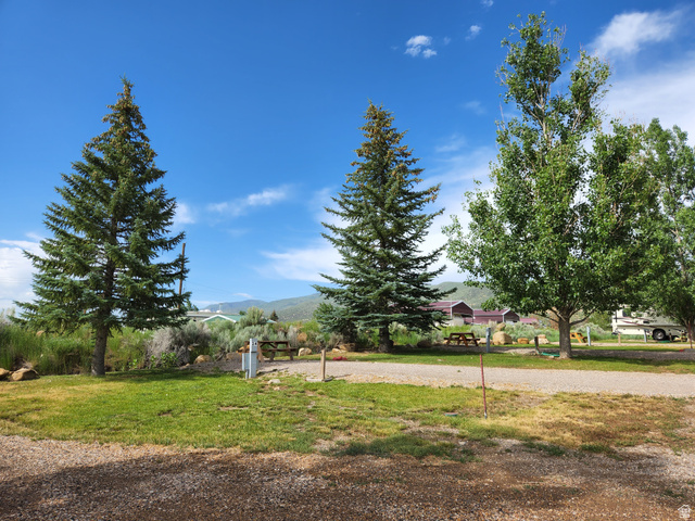 12615 Cedar Ridge Drive, Unit C41 Fairview, UT 84629 - Photo 20 of 32 View of green lawn featuring volleyball court and a mountain view