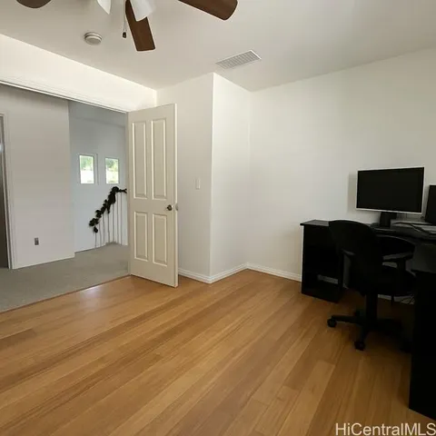 a workspace with wooden floor and a window