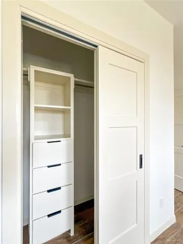 a kitchen with kitchen island stainless steel appliances a sink a center island and a wooden floor