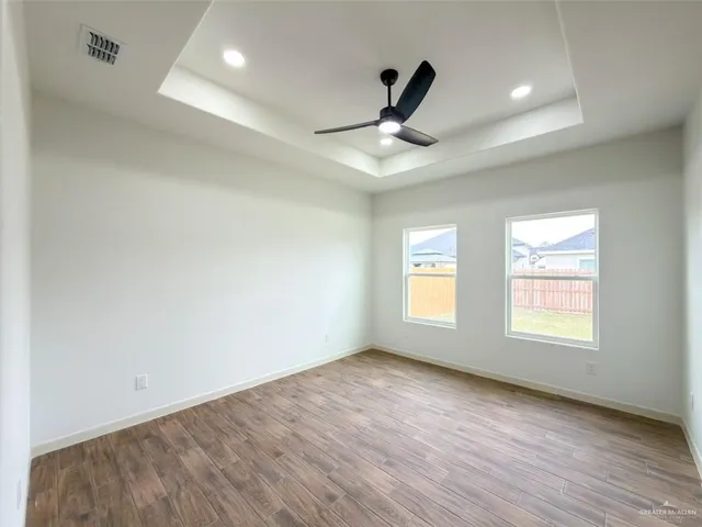 a view of a hallway with wooden floor and entryway