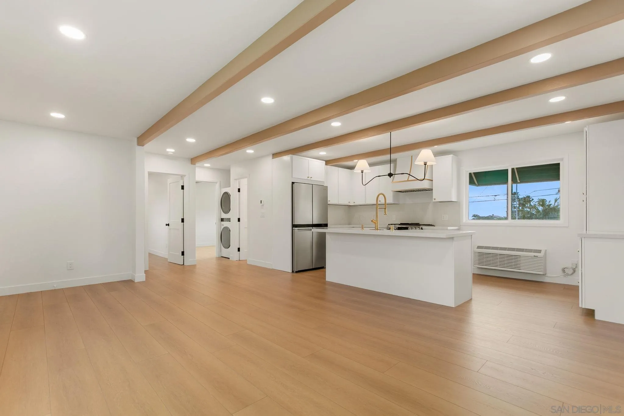 210 A Street, Unit 9 Encinitas, CA 92024 - Photo 11 of 41 a view of a kitchen with a sink and white cabinets
