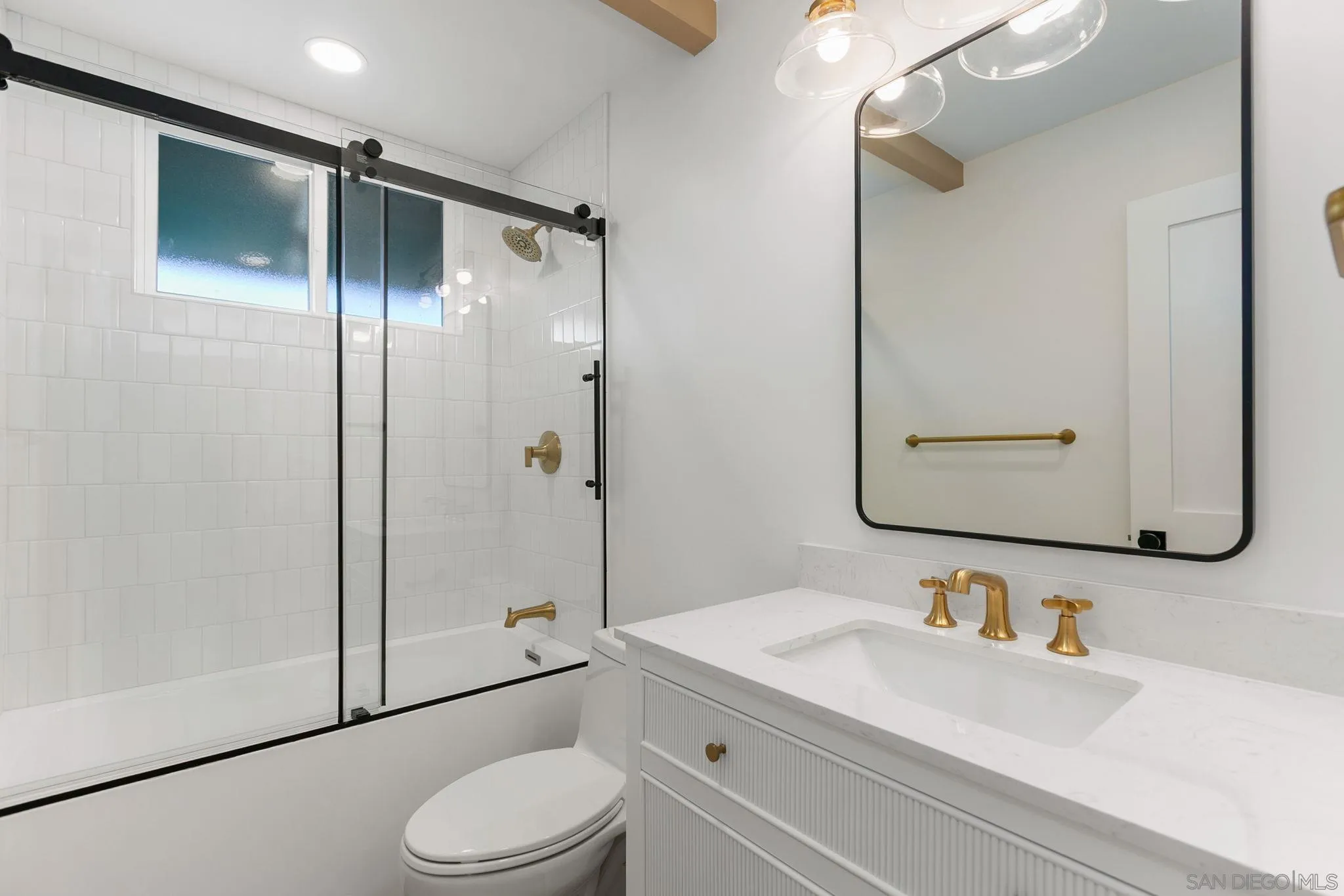 210 A Street, Unit 9 Encinitas, CA 92024 - Photo 19 of 41 a bathroom with a granite countertop sink toilet mirror and shower