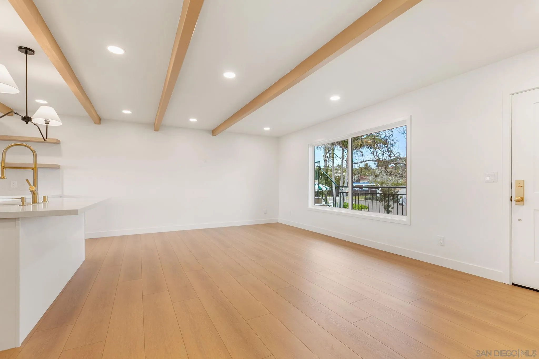 210 A Street, Unit 9 Encinitas, CA 92024 - Photo 10 of 41 an empty room with wooden floor and windows