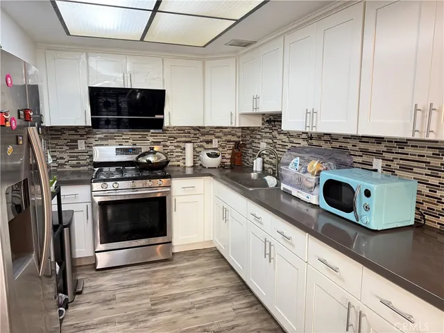 a kitchen with a stove and a microwave